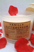 Vanilla buttercream candle with red rose petals on a white background